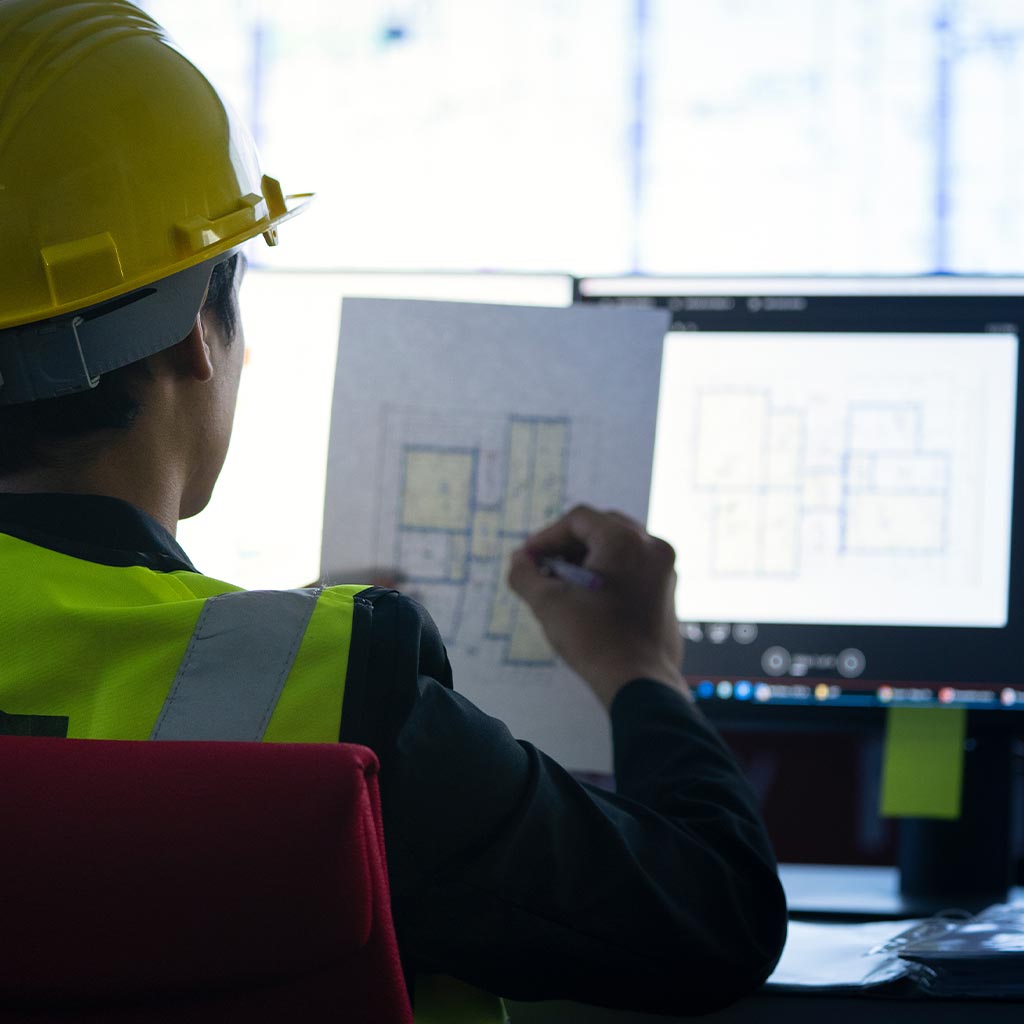 technician looking at plans in data center